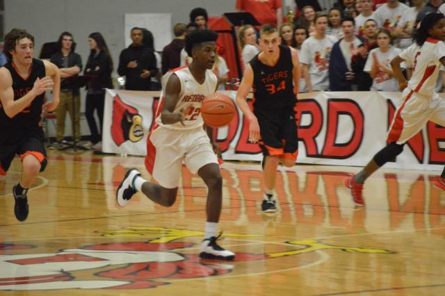 Kevin Caldwell moves the ball down the court for Alton against Edwardsville. (Photo by Brent Feeney)