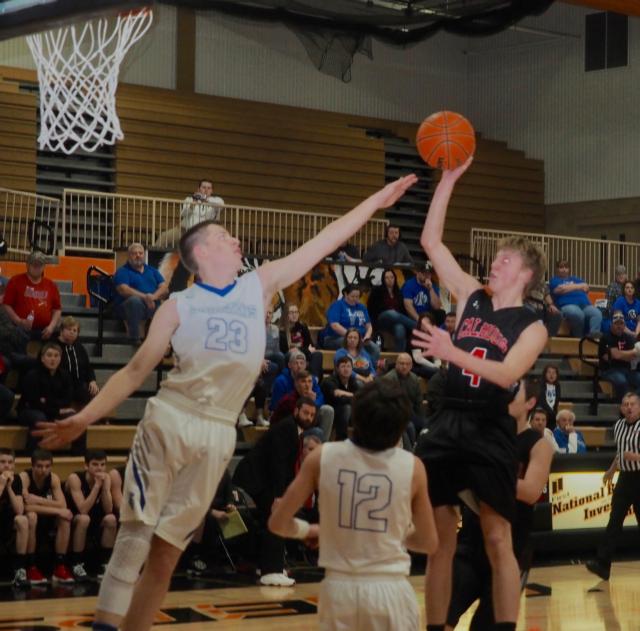 Chandler Sievers attempts a shot as Jonah Hopper tries to block it.