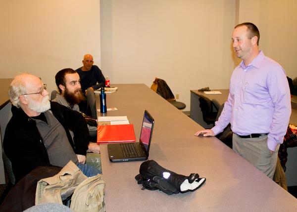 L&C Restoration Ecology students John Allison, far left, and Jimmy Greene discuss fracking with Green Series Guest Speaker Jim Kron, right, of SCI Engineering, during the first Green Speaker event Jan. 23. Photo by Louise Jett, L&C Media Specialist