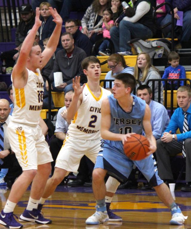 Caden Clark and Jaxen Helmkamp focus on Jacob Ridenhour.