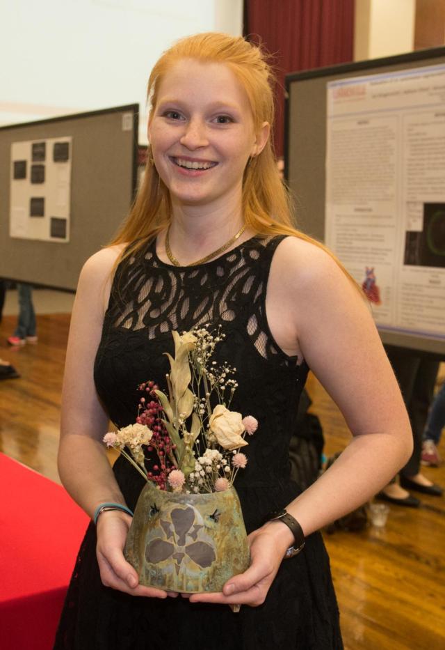 Sarah O&rsquo;Brien, of Flora, holds one of her metalsmithing creations on which she used the inlay technique of marriage of metals.
