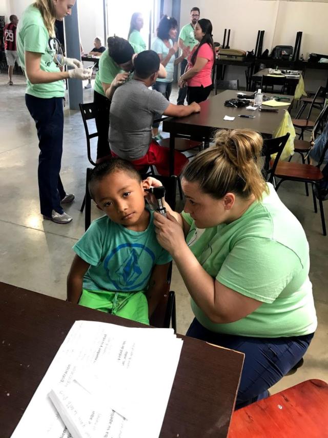 SIUE School of Nursing student Amanda McDannald is assessing the ears of one of her Costa Rican patients.