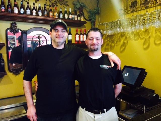 Younger brother Dave Princivalli (left) and older brother Jason Princivalli (right) stand in the Speak Easy Bar, located in the back Princivalli's Cafe.