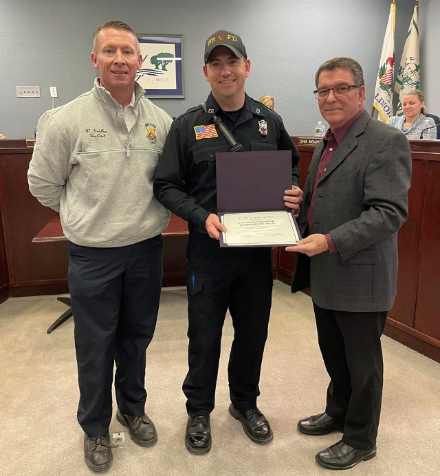 Wood River Firefighter of the Year Kris Ayers. (center).