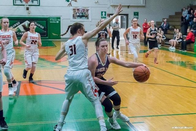 Bunker Hill's Mallory Schwegel drives the basket against Greenfield-Northwestern in the final game of her high school career. (Photo courtesy of Michael Weaver)