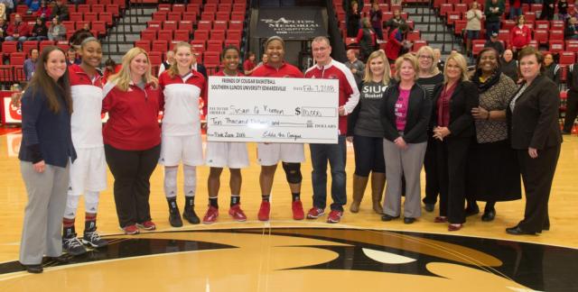 SIUE Women’s Basketball and the Pink Zone committee present a check for $10,000 to Susan G. Komen Missouri.