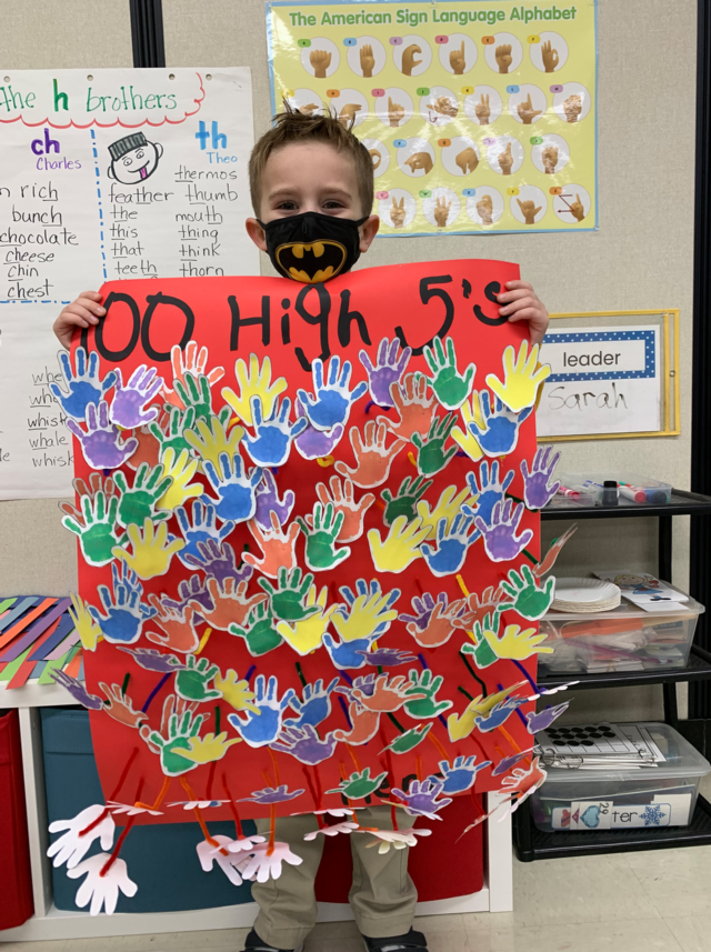 Henry Roosman with his poster of 100 high fives.