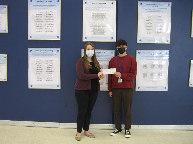 Cole Martinez, senior, is congratulated by Cassandra Ayres of Jersey State Bank.