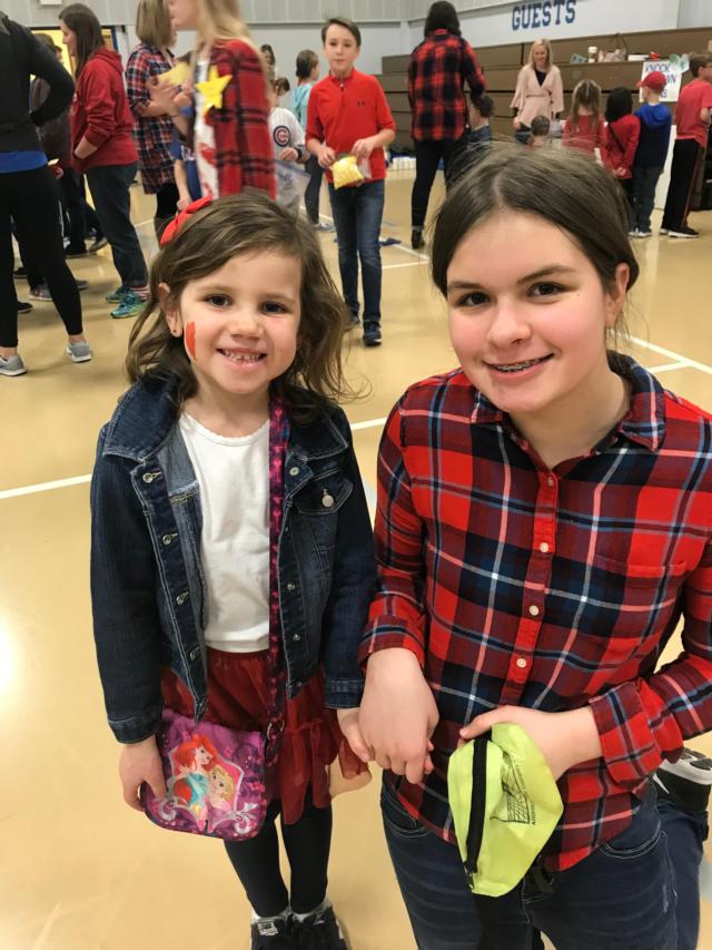 Ellie Luchtefeld and her 7th grade buddy Maddie Burkart check out the Mission Carnival at St. Boniface.