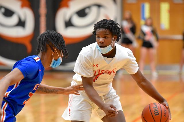 Jordan Bush handles the ball for the Tigers against the Flyers. (Photo by Dan Brannan)