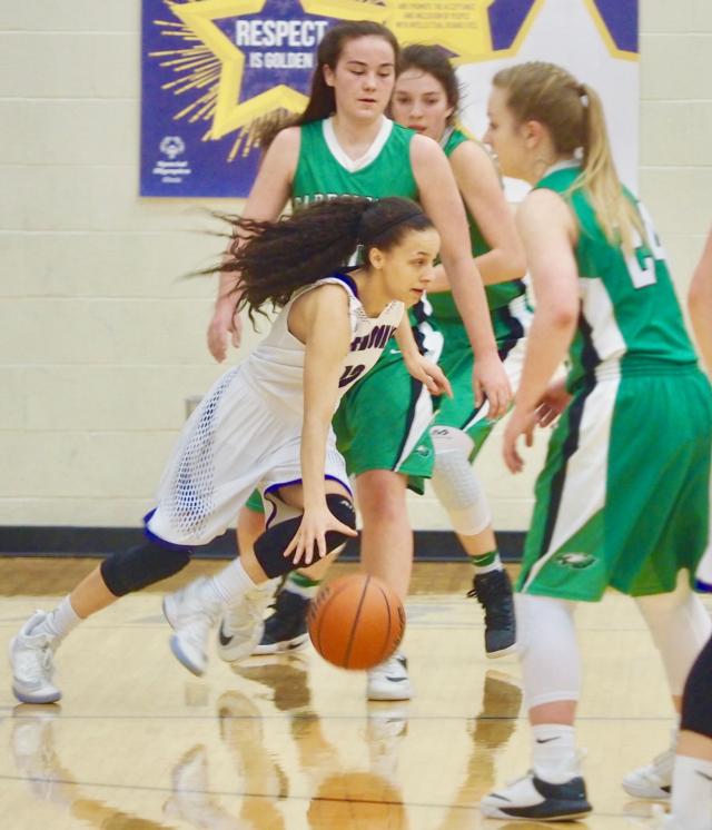 Lebanon's Krista Bass dribbles around Carrollton's Claire Williams and Hannah Krumwiede in the White Hall (North Greene) Sectional Semifinals.