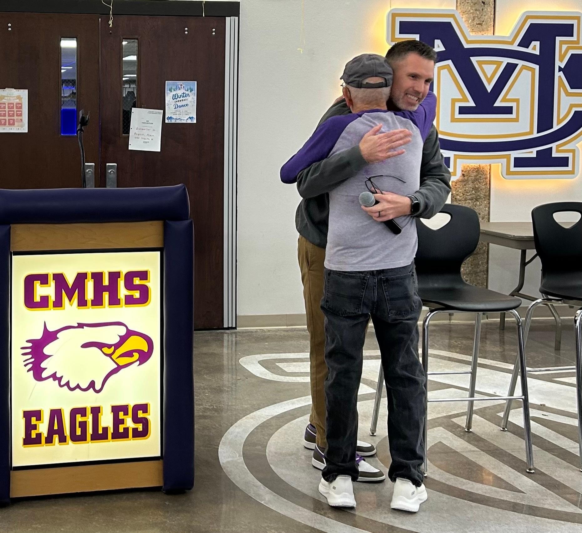 Wallace hugs Newell as the ceremony begins.