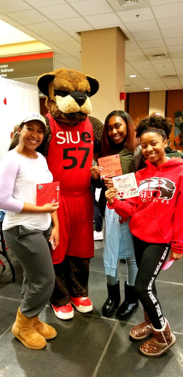 Maree’ Slack (left) and friends pose with Eddie the Cougar after he offered them a valentine.