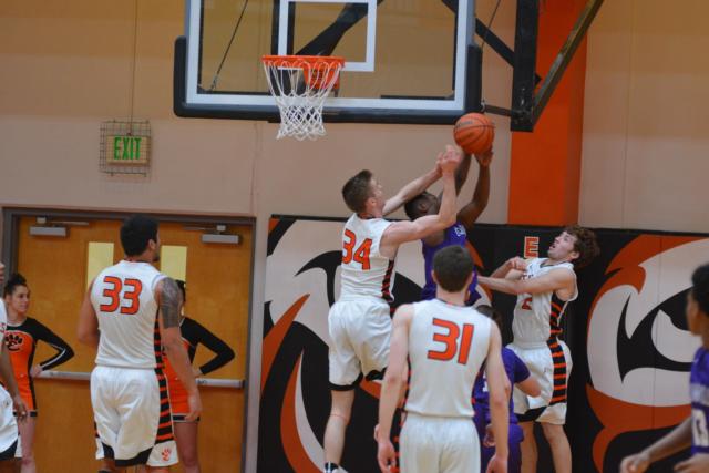 Caleb Strohmeier wrestles for a rebound with a Collinsville foe. (Photo by Dan Brannan)