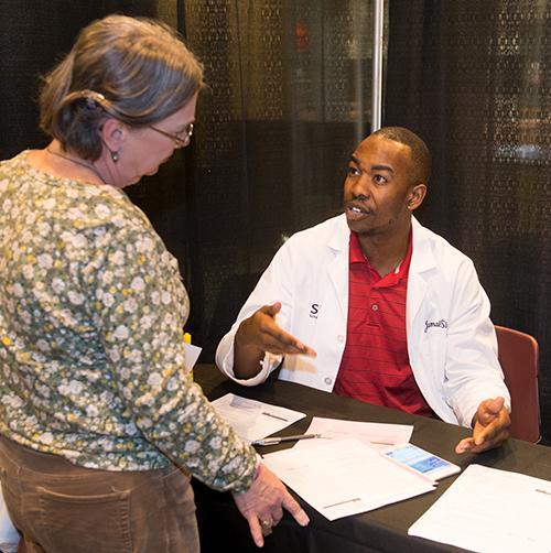 School of Pharmacy student Jamal Sims visits with Cheryl from Highland at SIUE’s 11th annual Free Diabetes Education Program.