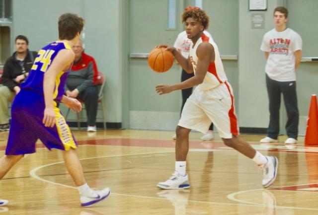 Darrell Smith brings the ball up court as he's guarded by Justin Wright (24).