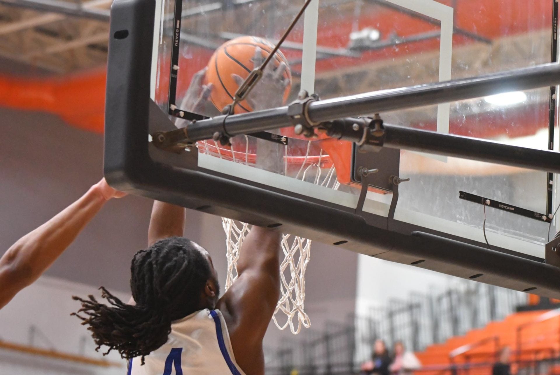 Devyon Hill-Lomax has been electrifying at the net as of late for the Tigers. He is shown on two slam dunks, the first two photos are from one slam and the last is from another in the first half of the game against Belleville East on Tuesday. The 6-foot-5 standout athlete has exceptional leaping ability. (Photos by Dan Brannan).