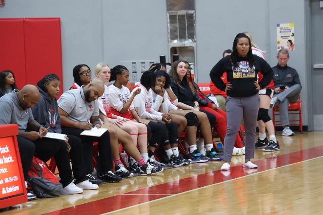 Alton Head coach Deserea Howard and the rest of her team watches on from the bench. 