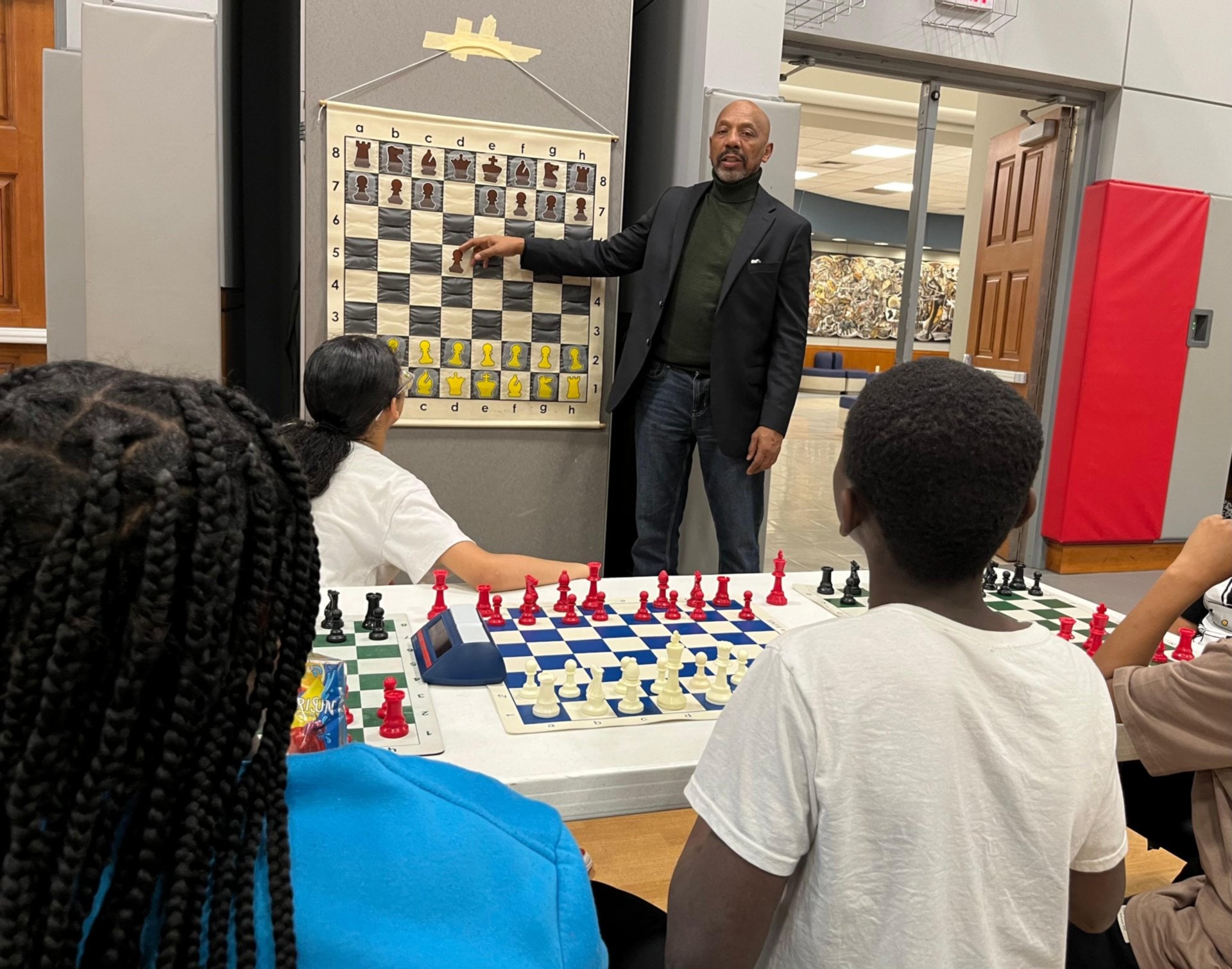 Phillip Berry teaches the game of chess to Project Success youth on the Wyvetter H. Younge Higher Education campus.