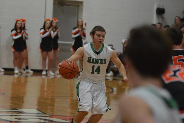Luke Gillingham brings the ball up court for the Carrollton Hawks on Friday night. (Photo by Dan Brannan)