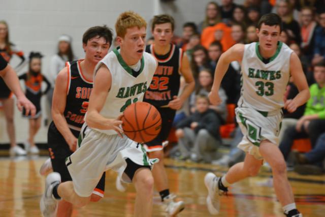 Carrollton's Tyler Frye dribbles quickly down court as Levi Hinderhan follows on Friday night. (Photo by Dan Brannan)
