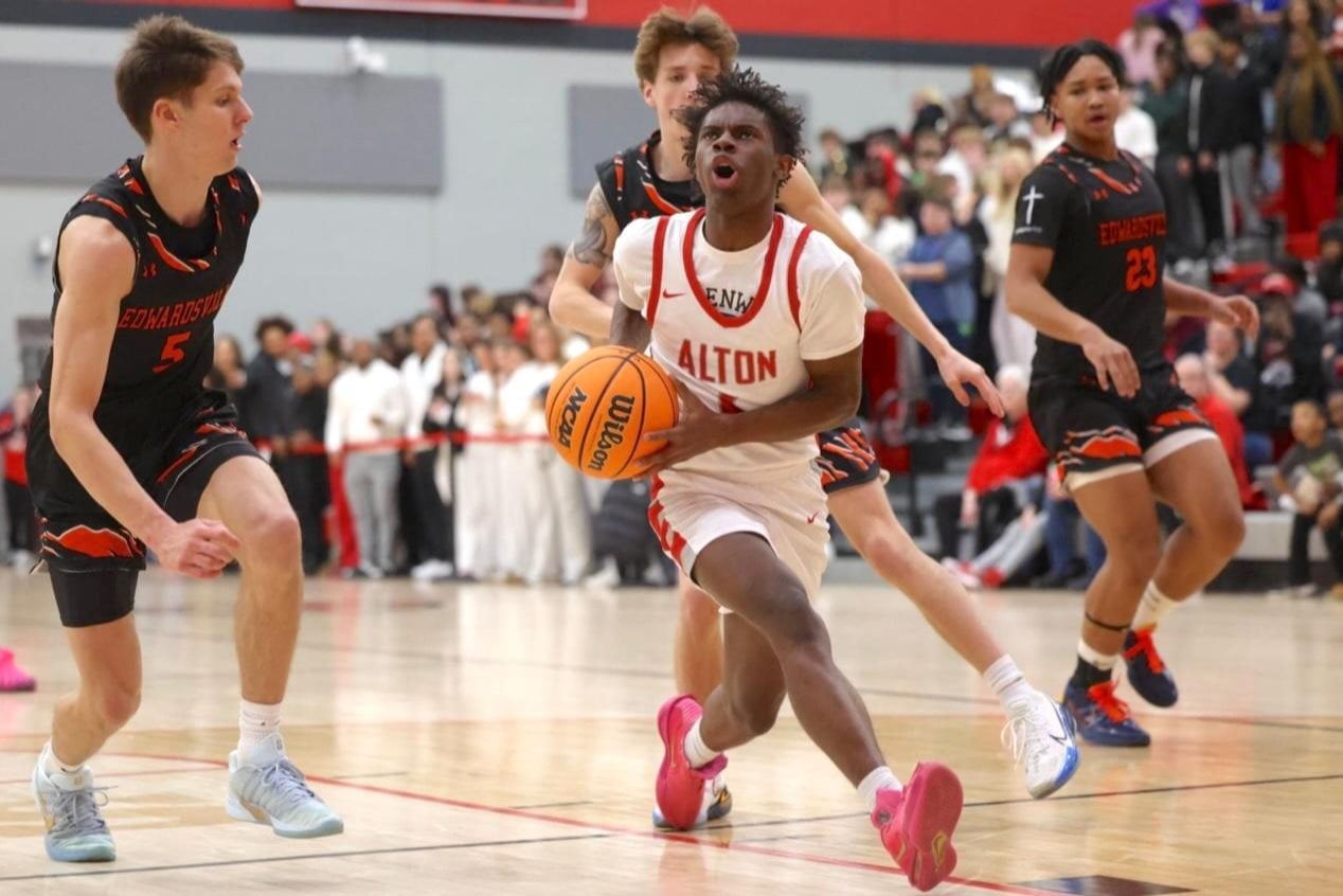 Alton's Tysean Jones drives the basket in an earlier game against rival Edwardsville. (Photo by Brad Piros).