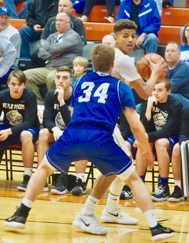 JaQuan Adams getting closely guarded in the corner by Jacob O'Connor (34).