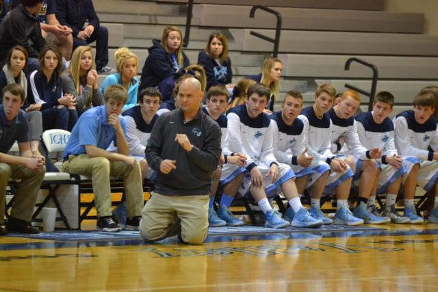 Jersey coach Stote Reeder slides to his knees on the sidelines of the Jersey-Triad matchup on Monday night.