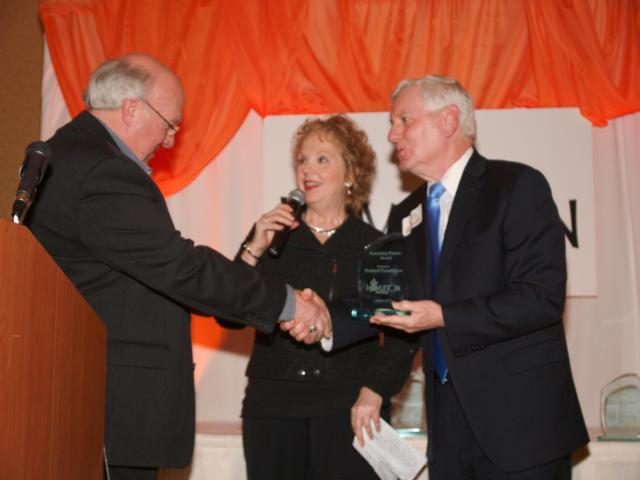 Rev. Don Jones, Hoyleton Ministries Board of Directors, presented the Sustaining Partner Award for 2014 to the Poshard Foundation during the 32nd Annual Hoyleton Ministries Awards and Recognition Banquet on February 6, 2015.