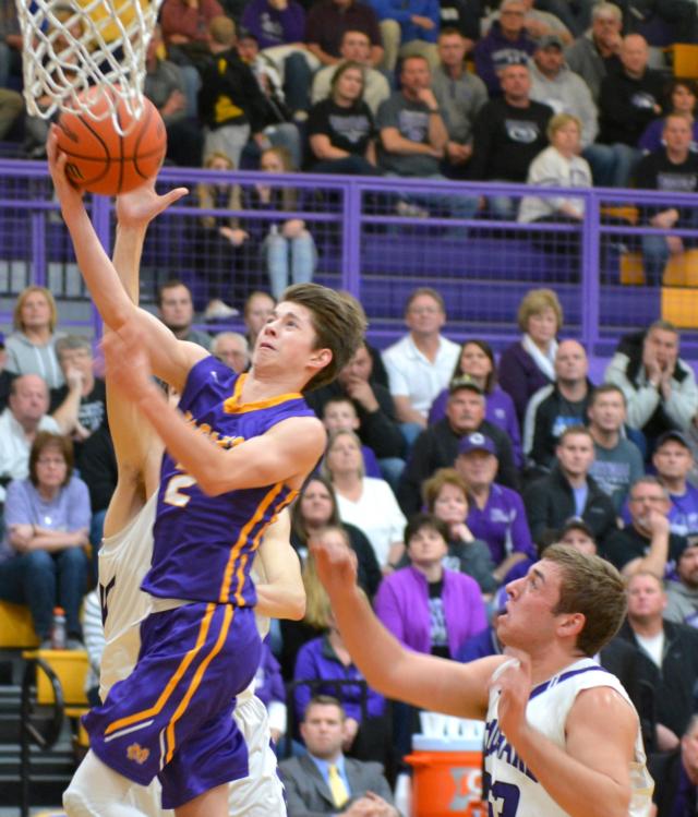 Caden Clark lays the ball in the basket for Civic Memorial on Friday night. (Photo by Dan Brannan)