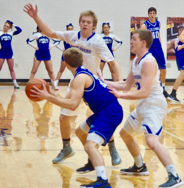 Columbia's Jordan Holmes gets double-teamed by Marquette's Sammy Green (3) and Reagan Snider (23) in the Class 3A Waterloo Regional Championship on Friday night.