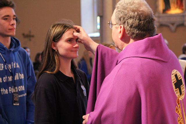 Students receive their ashes at the Mass Wednesday at St. Mary's Catholic Church.