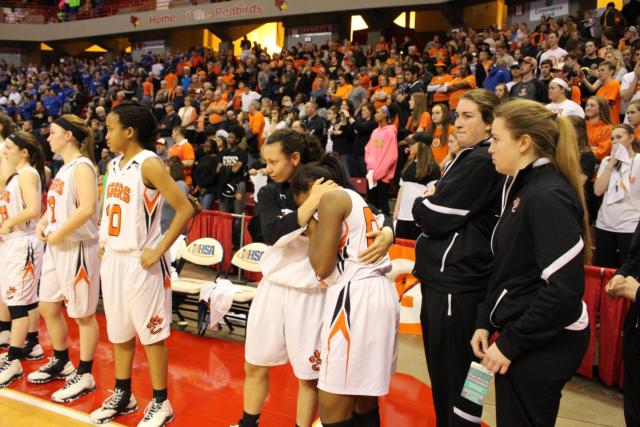 Jasmine Bishop comforts Quierra Love after the game on Saturday.