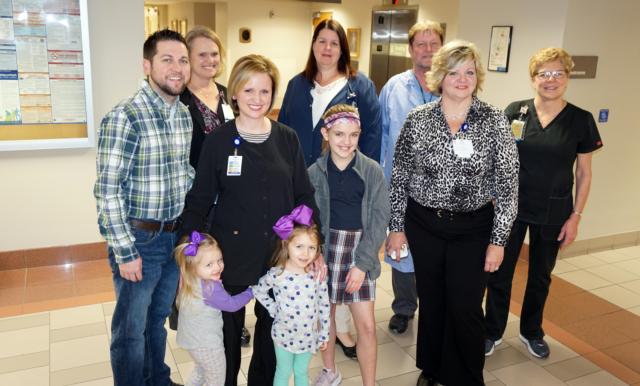 Jamie Gross, of Respiratory Therapy, second from left surrounded by family and co-workers, who is the Alton Memorial Hospital March Employee of the Month. 