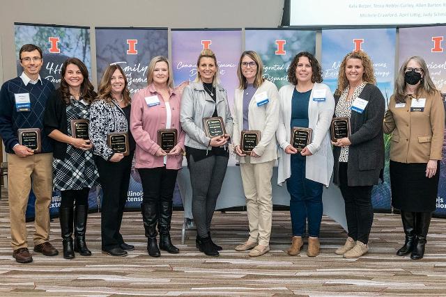 Nine Illinois Extension professionals were recognized for their development of the Illinois Strong Couples program. Extension Director Shelly Nickols-Richardson, far right, presented the award to, left to right, Extension specialist Allen Barton; and educators Karla Belzer, Tessa Hobbs-Curley, Robin Ridgley, Cheri Burcham, April Littig, Judy Schmidt, and Melissa Wilson. Michele Crawford was not present for the photo.