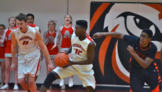 Isaiah Thurmond and teammate Bryan Hudson appear off to the races with the ball Friday night at Edwardsville. Edwardsville's Jordan Harris closely follows them. (Photo by Dan Brannan)