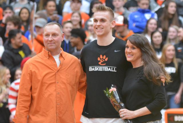 Tigers' star forward Caleb Strohmeier with his parents on Senior Night.