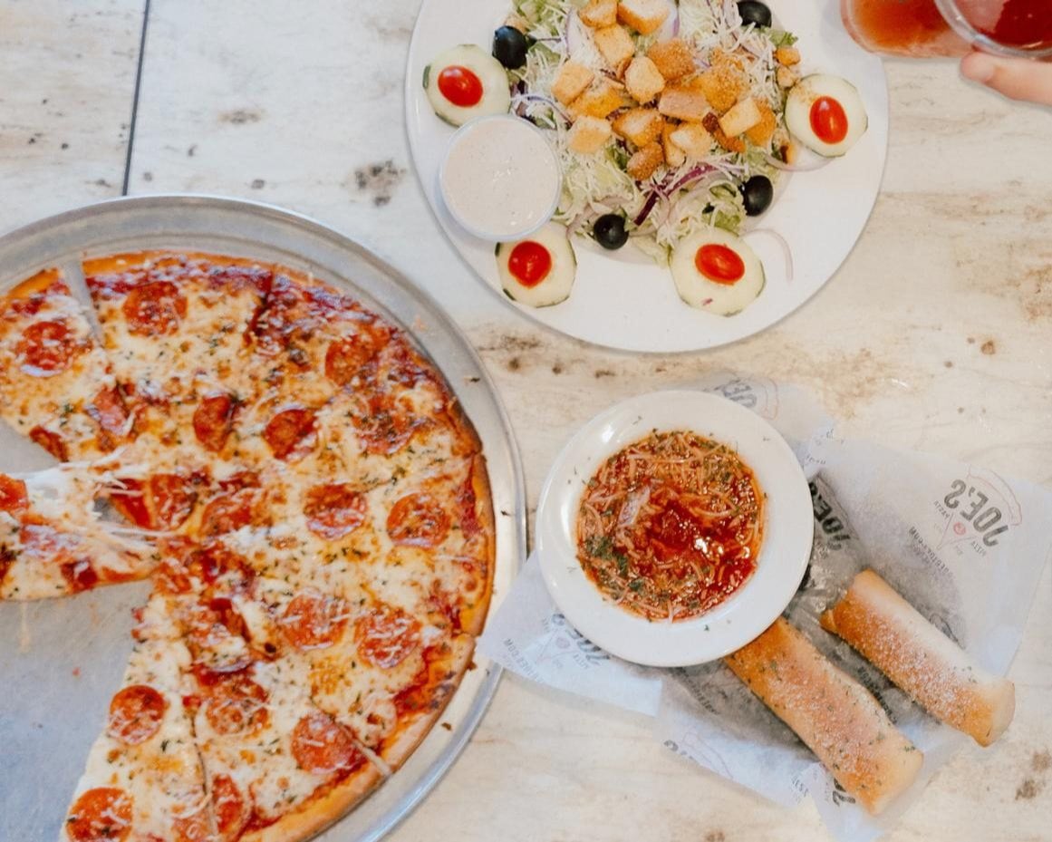 XL 2-Topping Pizza, Garlic Sticks, Large Salad, and Soft Drinks starting at $29.99