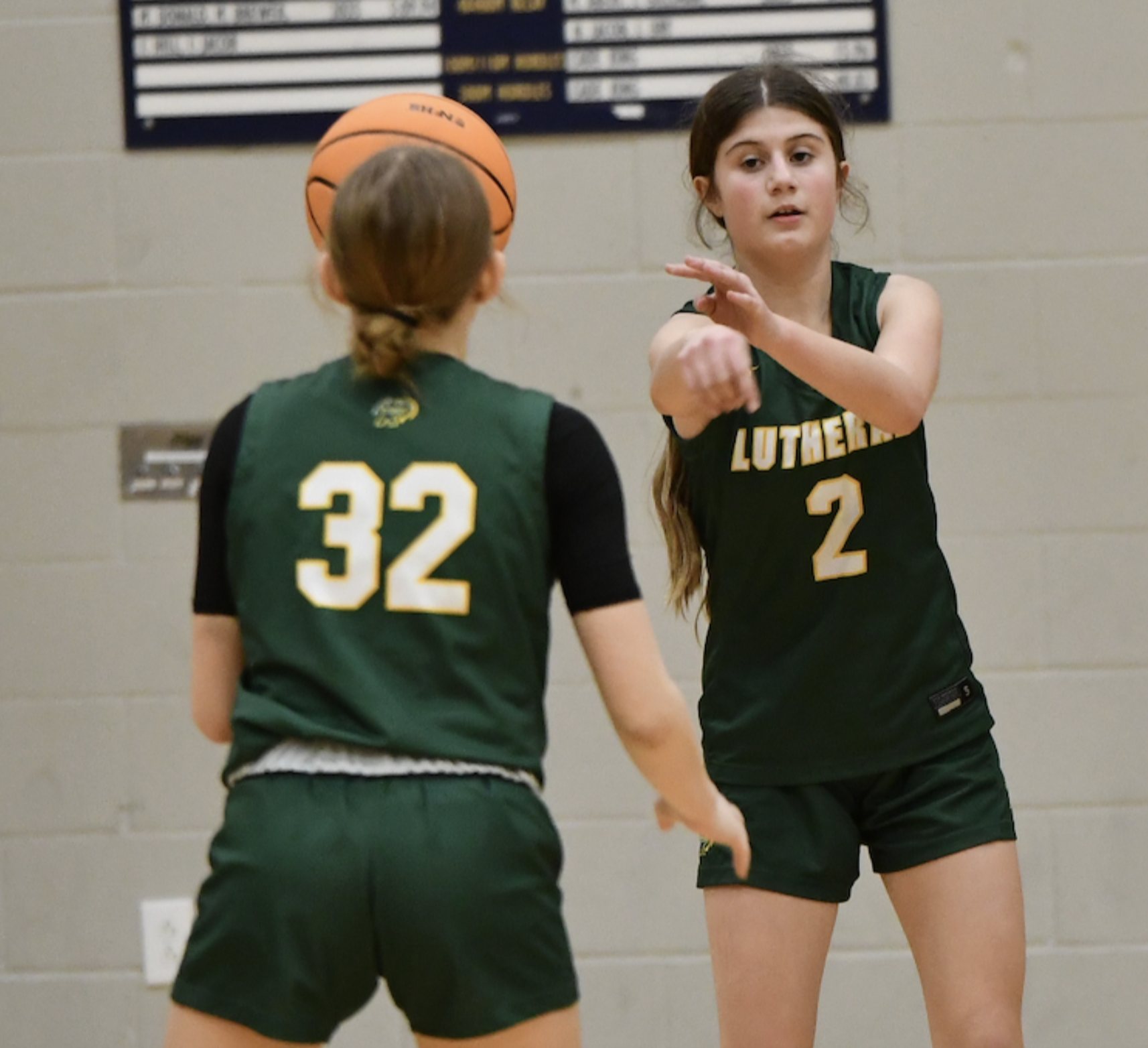 Cally Shank, No. 2, passes the ball for Metro East Lutheran High School. (Photo by Dan Brannan).
