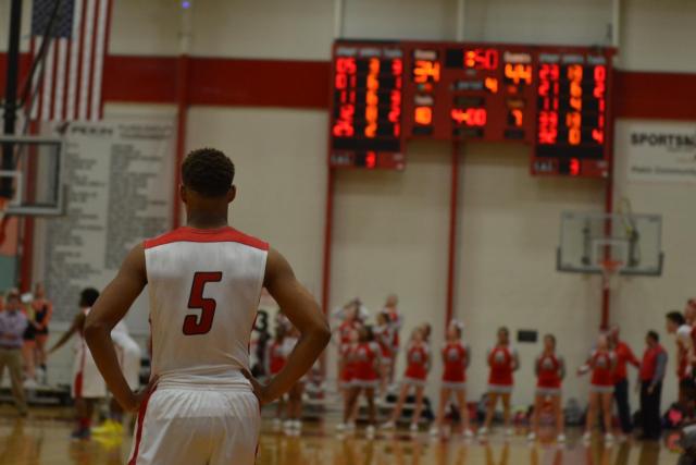 Senior LaVonte Hobbs positions himself at the end of the quarter waiting for a quick basket toward the end of the game with Normal on Friday night.