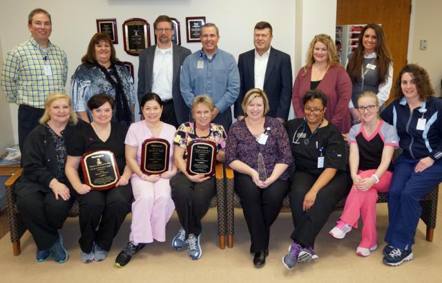 Healogics presented three awards to the AMH Wound Care and Hyperbaric Medicine Center on March 6. Front row, left to right, are Tammy Miller, front office coordinator; Kathy Ridenhour, RN; Kary Holliday, RN; Kathy Kliefoth, RN; Erica Brown, RN, clinical nurse manager; Dr. Valinda Allen, medical director; Katie Alexander, RN; and Tonya Ballard, HBO safety director; standing in the back, left to right, are Matt Flick, program director; Debbie Turpin, vice president of Patient Care Services; Dr. Sebastian Rueckert, vice president/chief medical officer; Rusty Ingram, director of Business Development; AMH President Dave Braasch; Heather Wahlbrink, area vice president for Healogics; and Kim Gass, regional director of Clinical Operations for Healogics. Not pictured are Jana Lybarger, RN; Bernice Smith, RN; Dr. Jacob Lamb; Dr. Krista Nelson; and Dr. Olusegun Coker.