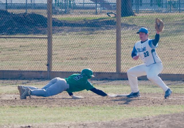 Alex Bowker reaches back to first base safely after a pickoff attempt by Triopia.