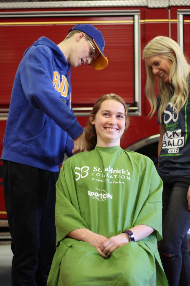 Ryan Luer cuts the hair of his sister, Jessica, for St. Baldrick's.