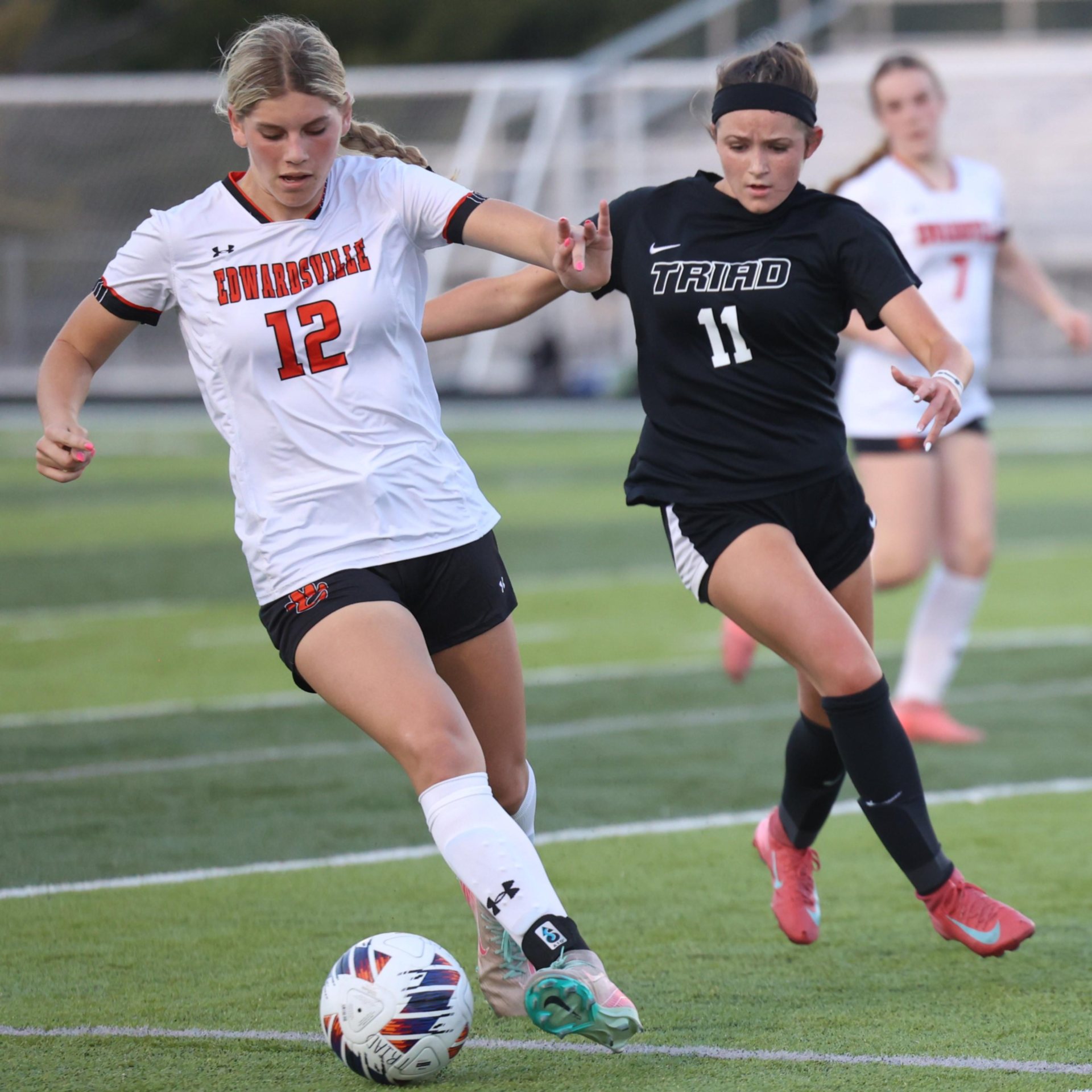 Edwardsville&rsquo;s Madison Kline shields the ball from Triad&rsquo;s Averi Moore Thursday evening in the two teams&rsquo; season-opener at Triad High School. (Photos by Brad Piros)