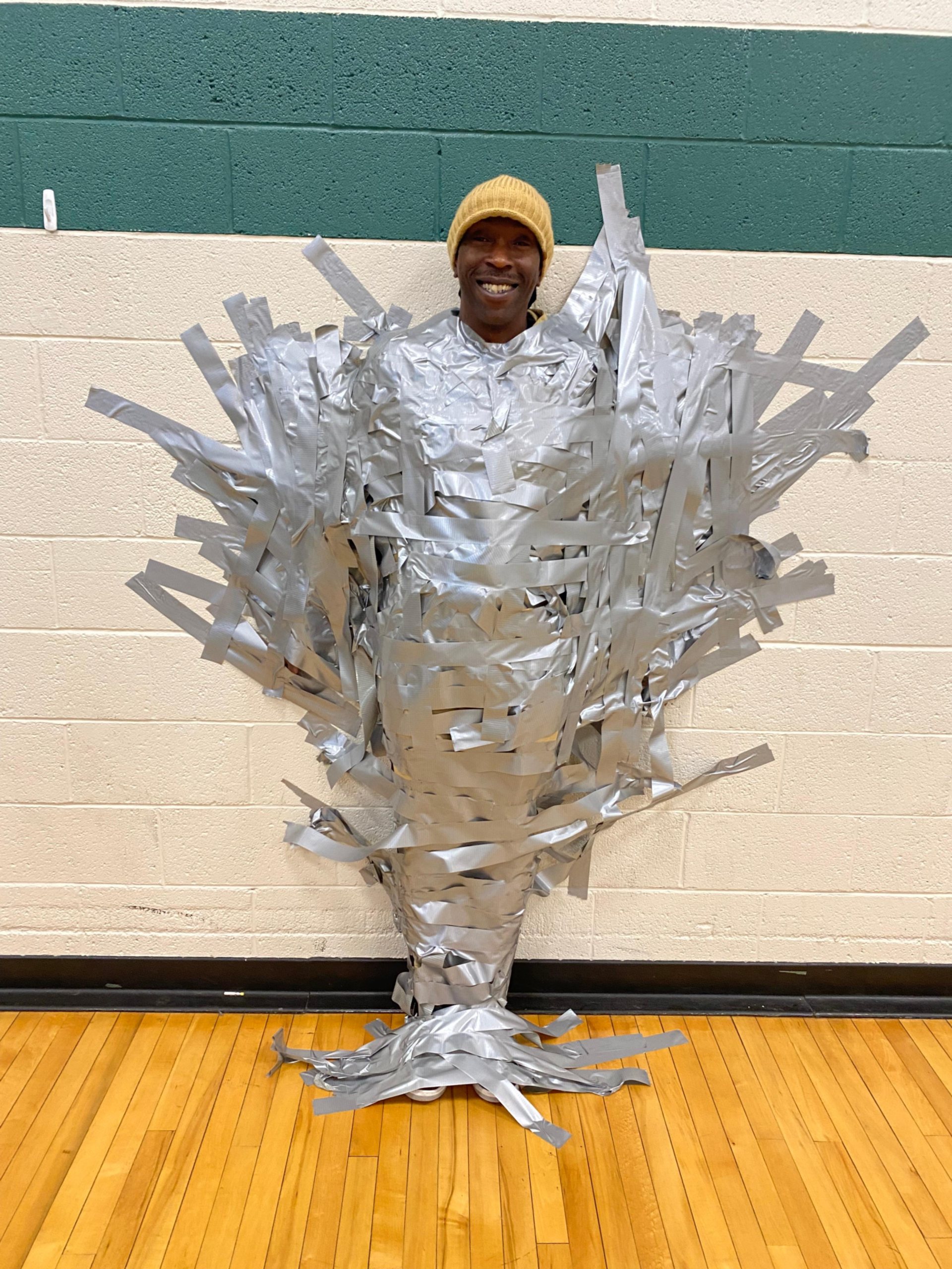 Dominique Williams, a safety aid at North Elementary School, is taped to the wall as part of the campaign fundraising.