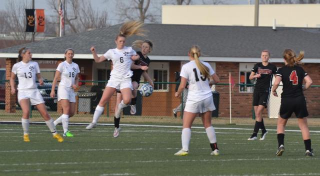 Jocelyn Wagner squares off with a Springfield opponent as Ashlin West (13); Allysiah Belt (16); and Lexi Norton (15) look on in soccer action on Friday at Edwardsville.