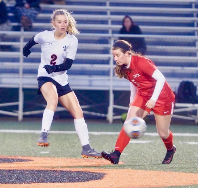 Edwardsville's Ezri Beckman fires an-balance pass in front of Incarnate Word's Pabst on Wednesday at Edwardsville High School.
