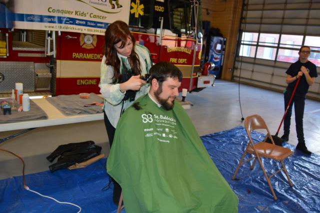 Edwardsville Fire Department chaplain Jordan Dollar donates his hair to the St. Baldrick's Day cause. (Photos by Dan Brannan)