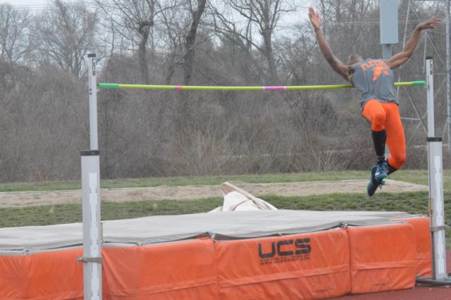 An East St. Louis high jumper moves to clear the bar.