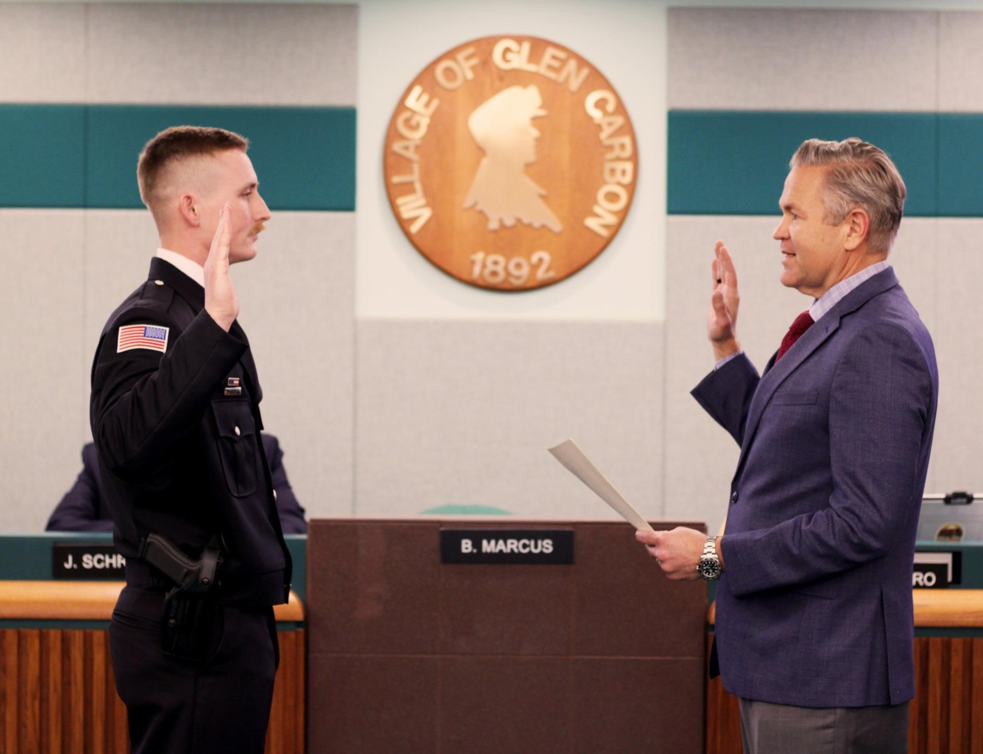 Officer Aaron Brooks is sworn in by Mayor Bob Marcus.